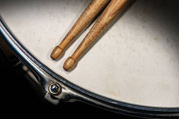 istock Two wooden drumsticks on an old snare drum - Percussion instrument 1201640974