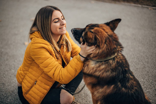 istock Beautiful young woman with dog 1201641414