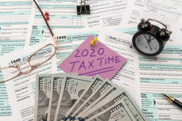 istock US tax form with money. 1201642519