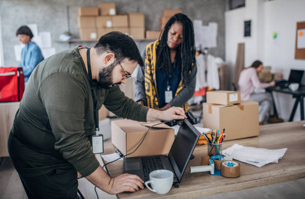 istock Man using laptop for arranging customers orders for drop shipping 1201642533