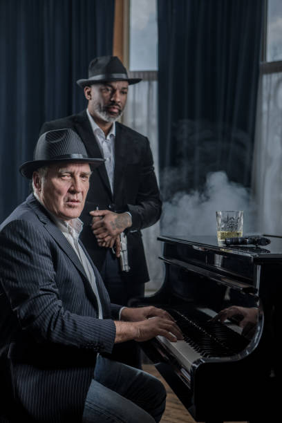 istock Senior Piano Playing Man with a bodyguard 1201642683