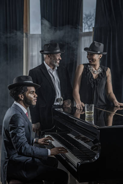 istock Black Piano Playing Man with friends 1201642816