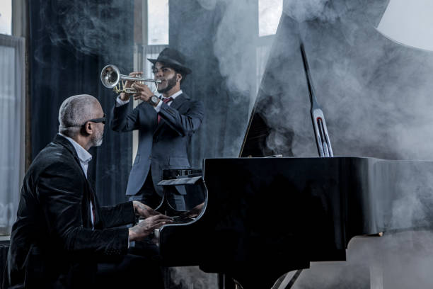 istock Black Piano Playing Man and a trumpet player 1201643461