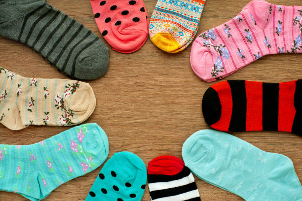 istock Colorful socks on wooden background. 1201643581
