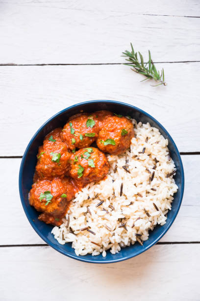Homemade meatballs with tomato sauce and parsley in a bowl