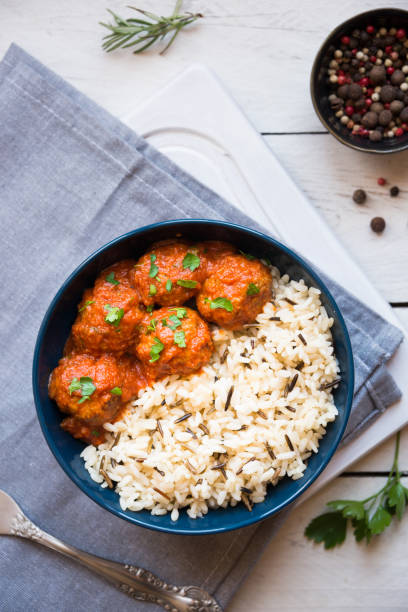 Homemade meatballs with tomato sauce and parsley in a bowl