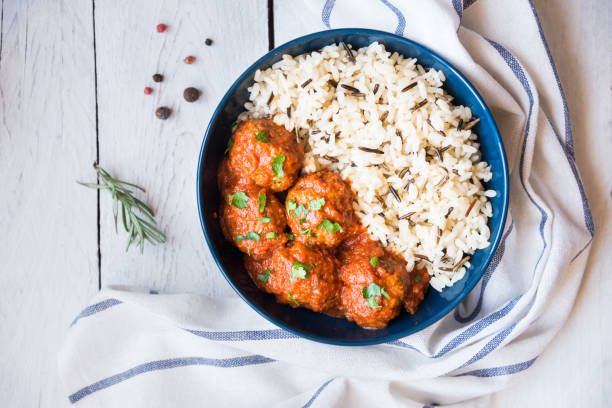 Homemade meatballs with tomato sauce and parsley in a bowl