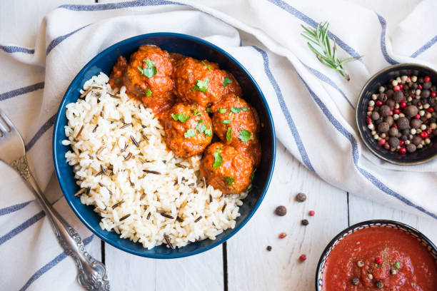 Homemade meatballs with tomato sauce and parsley in a bowl