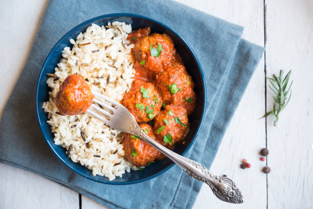 Homemade meatballs with tomato sauce and parsley in a bowl