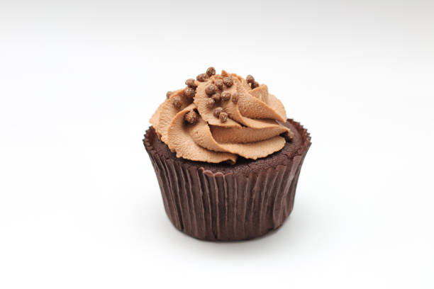 istock Isolated chocolate cupcake with cream top and crispy topping on a white background 1201645208
