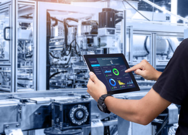 Smart industry control concept. Hands holding tablet on blurred automation machine as background manufacturing equipment stock pictures, royalty-free photos & images