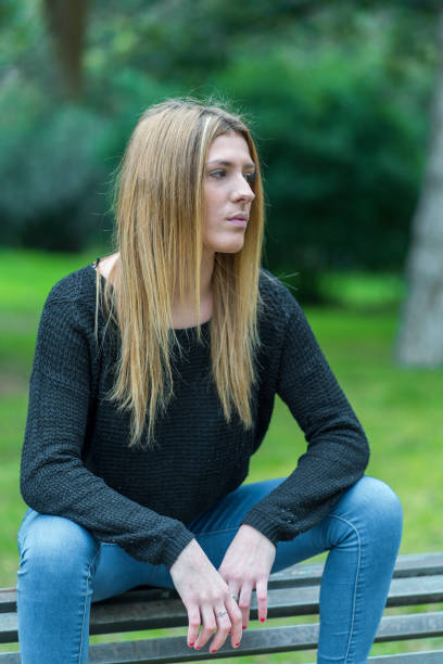 istock Woman in a park 1201645577
