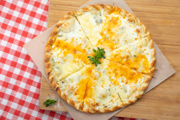 istock Pizza with different cheese close-up with different ingredients decorated with Basil 1201646716