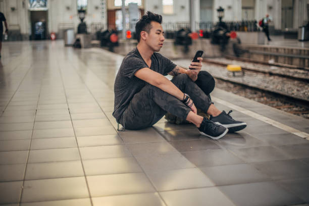 istock Man sitting on the train station 1201646802