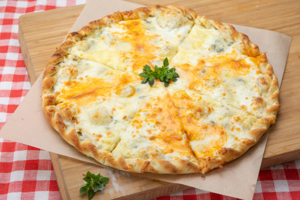 istock Pizza with different cheese close-up with different ingredients decorated with Basil 1201647075