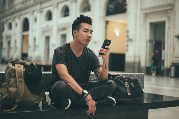istock One man sitting on the train station 1201647637