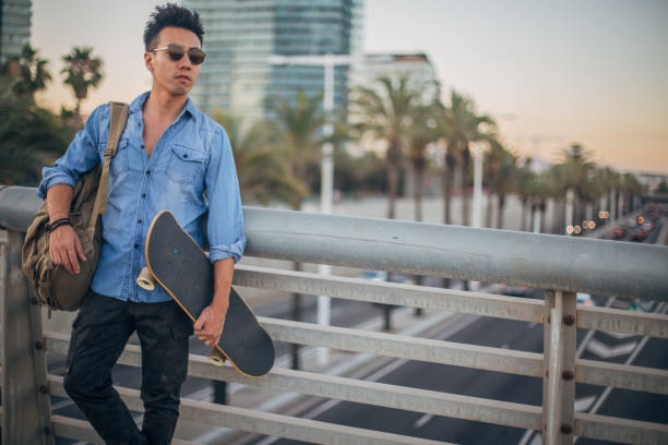 istock One hipster man with skateboard on the street 1201648689