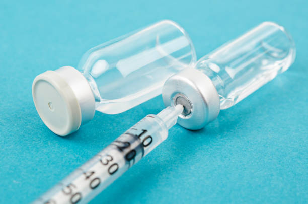 istock Vaccine vial dose with needle syringe 1201648711