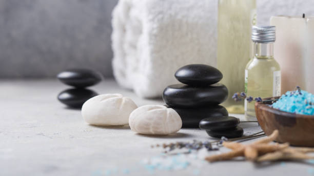 istock Massage. Composition with candles, spa stones and salt on concrete background. Spa and wellness setting ready for beauty treatment. 1201648715