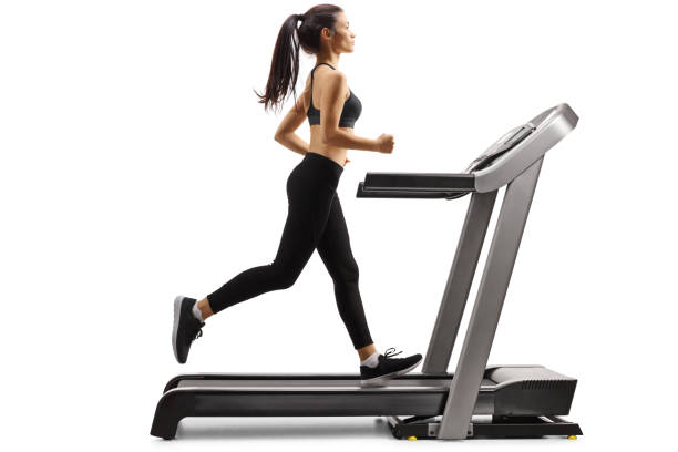 scatto a tutta lunghezza di una giovane donna snella che corre su un tapis roulant isolato su sfondo bianco - treadmill exercise machine isolated exercising foto e immagini stock