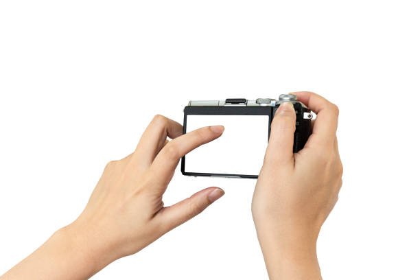 istock Hand holding DSLR digital camera.Isolated on white background with clipping Path. 1201650691