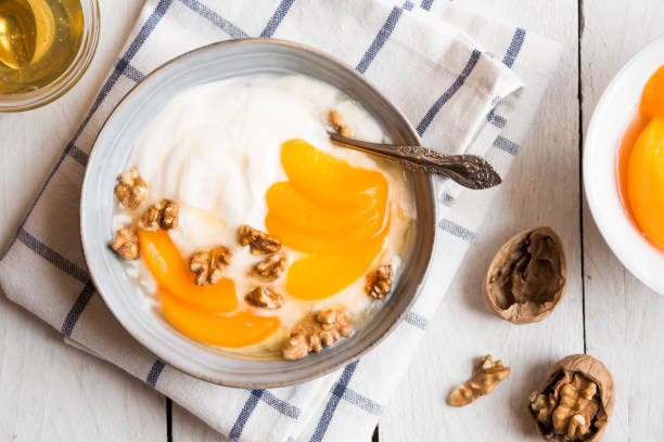 istock Yogurt with peach, nuts and honey in a bowl 1201651024