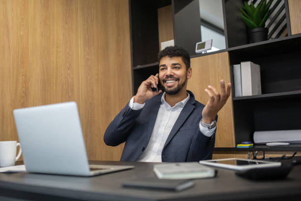 istock Businessmen talking on a phone in an office 1201651752