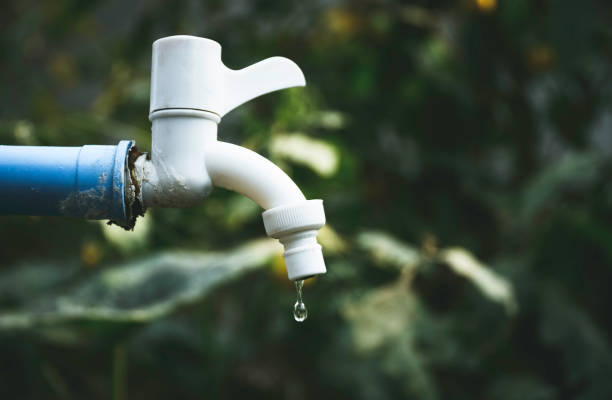 istock Closeup old water tap dripping in water shortage or drought concept. 1201652294