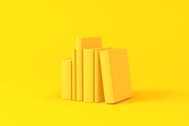 Books isolated over a yellow background. Minimalist concept. stock photo
