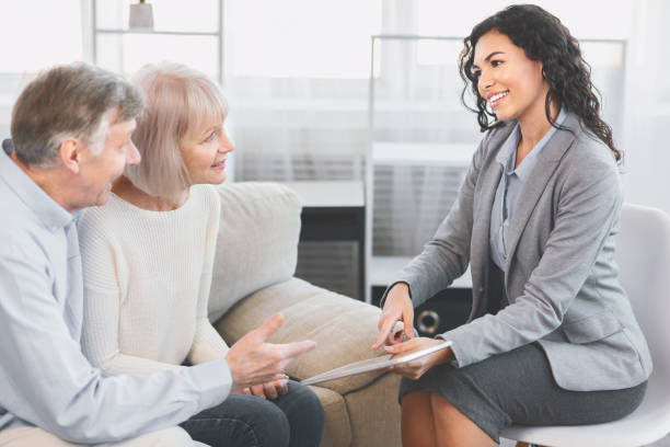 istock Senior couple talking to financial advisor at office 1201654328