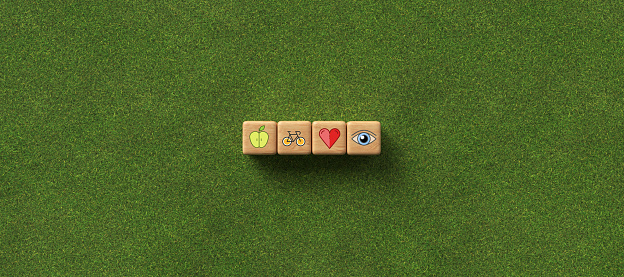 cubes with health icons on grass background - 3D rendered illustration