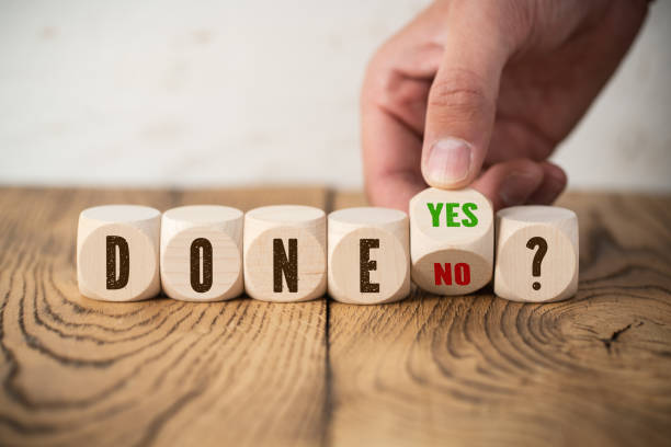 istock hand flips a cube with the answer to the question 