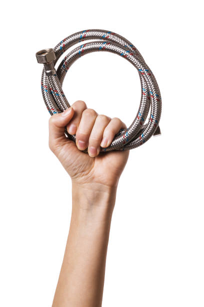 istock Female hand holds plumbing flexible hose isolated on white background 1201655433