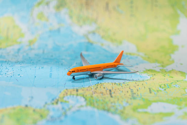 istock selective focus of toy plane on world map 1201655754