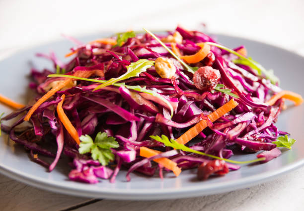 istock Delicious red cabbage salad. Cut red cabbage with other ingredients 1201656570