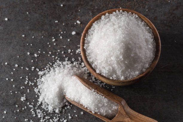 istock Crystaline sea salt in bowl and spoon - closeup. 1201656580
