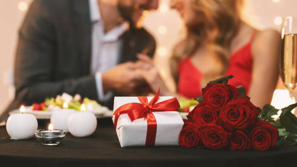 istock Romantic Couple Celebrating Valentine's Day In Restaurant, Holding Hands 1201656635