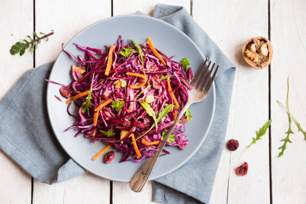 istock Delicious red cabbage salad. Cut red cabbage with other ingredients 1201656682