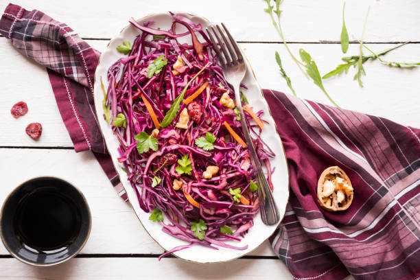 istock Delicious red cabbage salad. Cut red cabbage with other ingredients 1201656827