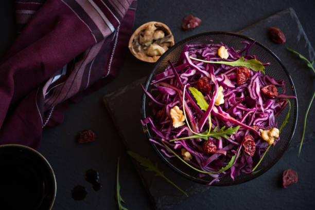 istock Delicious red cabbage salad. Cut red cabbage with other ingredients 1201656875