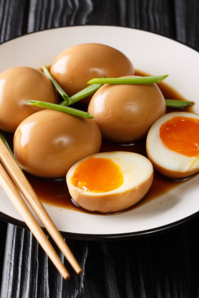 Japanese nitamago eggs close-up in a plate. vertical
