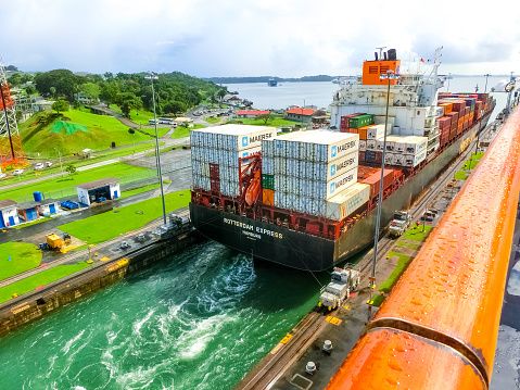 Panama Canal, Panama - December 7, 2019: Hapag-Lloyd cargo ship entering the Miraflores Locks in the Panama Canal, in Panama