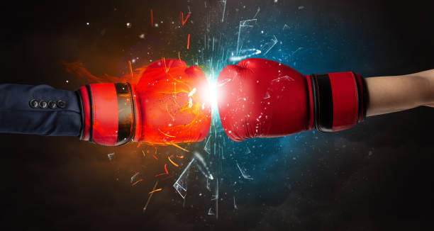 istock Fighting hands breaking glass with fire and water 1201659316