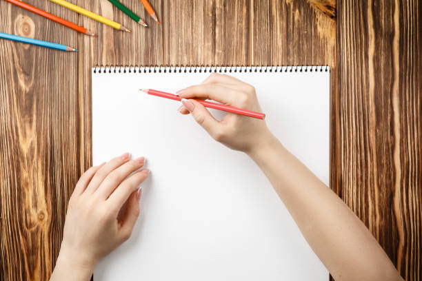 istock colored pencils and notepad on wooden table 1201659863