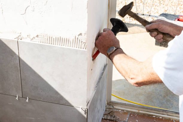 istock the mason prepares the wall with a chisel before laying a ceramic tile 1201662053