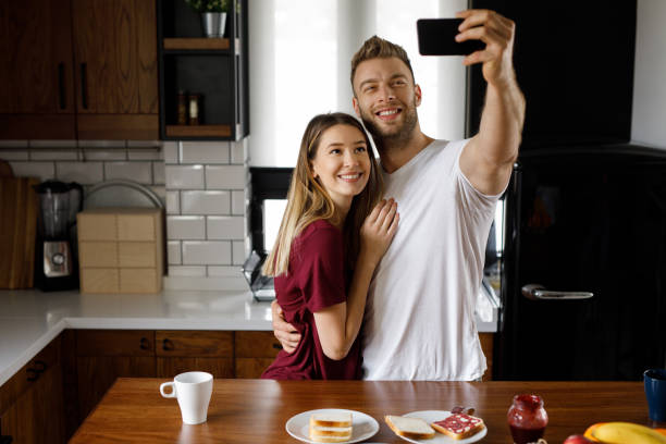 istock Couple taking a Selfie together in the kitchen during breakfast 1201662932