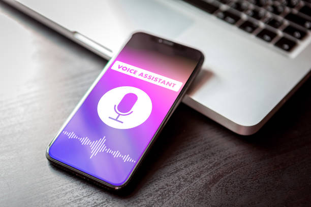 istock Voice assistant concept on smartphone. Closeup AI mobile phone siri sound recognition application 1201663042