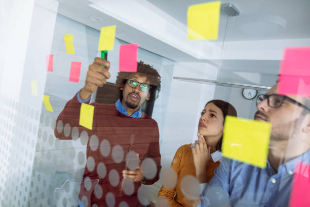 istock Business people brainstorming ideas behind glass wall 1201663906