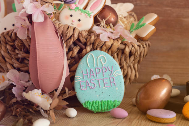 istock Happy Easter. Multicolored pastel easter cookies in a wicker basket  on a wood background 1201666638