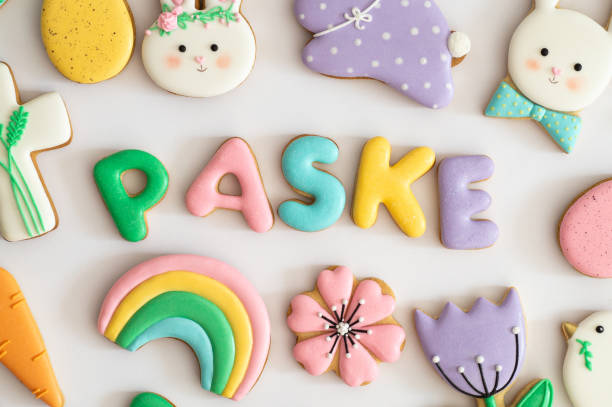 istock Happy Easter. Multicolored pastel easter cookies in a wicker basket  on a wood background 1201666692